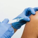 Close-up of a healthcare worker giving a vaccination injection to a patient