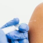 Close-up of a healthcare professional administering a vaccine.